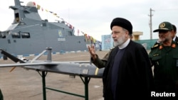 Iranian President Raisi (second left) inspects the Islamic Revolutionary Guards Corps' rising military capabilities in early February. 