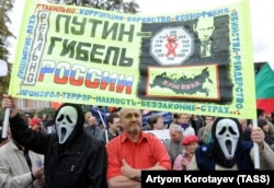 Demonstrators hold a banner reading "Putin is Russia's disaster" during a protest in Moscow in 2011.