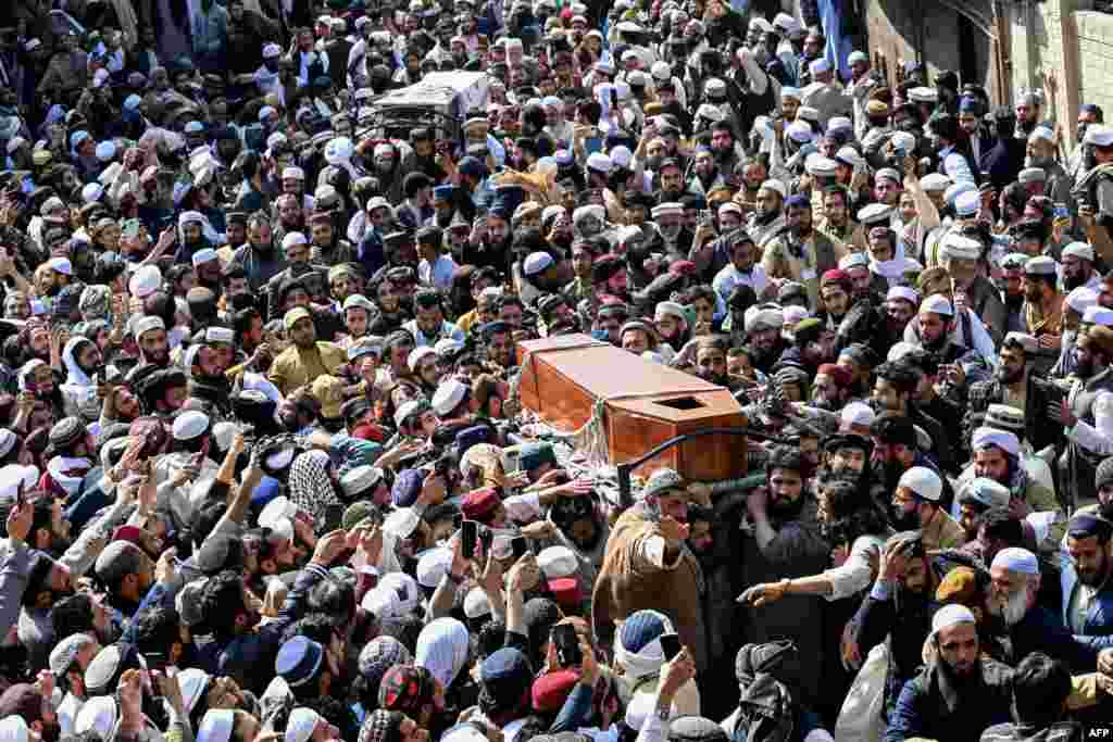 Mourners carry the coffin of Hamid ul Haq Haqqani, a Pakistani politician and cleric who was killed in a deadly suicide bombing in Khyber Pakhtunkhwa Province on February 28. 