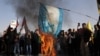 Supporters of the Iranian Islamic republic burn a painted Israeli flag in Tehran on October 2 during a gathering to support the missile attack on Israel the previous day.