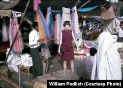 Jan Podlich is pictured during a shopping trip to Istalif, a village about 30 kilometers northwest of Kabul. "We arrived in Kabul one sunshiny morning in June.... My dad met us and was able to whisk us through the customs. We proceeded into Kabul in a UN 'kombi' (kind of an old-school SUV). I was tired, but I can remember being amazed at the sight of colorful (dark blue, green, and maroon) ghosts that were wafting along the side of the road. My dad explained there were women underneath those chadris and that some women had to wear them out in public. We never called the garments burqas."