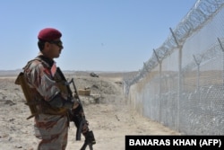 A Pakistani soldier stands guard along the border fence on the Pakistan-Afghanistan border near Quetta, Balochistan Province.