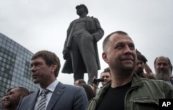 Oleh Tsaryov (left) is seen with separatist leader Aleksandr Borodai in Donetsk in June 2014.