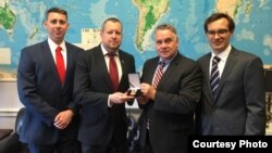 U.S. Representative Chris Smith (2nd right) receives an award from Belarusian opposition activists in May 2019.