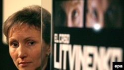 Marina Litvinenko stands by a poster for a documentary on the assassination of her husband.