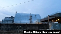 Damage from what Ukraine says was a Russian drone strike on a protective sarcophagus at Chernobyl on February 14.