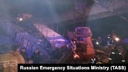 Rescuers work at the site of a bridge collapse in Nefteyugansk district near the village of Karkateyevy in the Khanty-Mansiisk region on November 5.