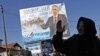 An electoral billboard goes up for a Serbian-minority party in Gracanica.