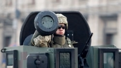 A Ukrainian soldier rides with a Javelin anti-tank missile as he takes part in a rehearsal of a military parade in Kyiv in August 2018.