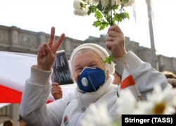 A woman takes part in a march by pensioners in Minsk on October 26.