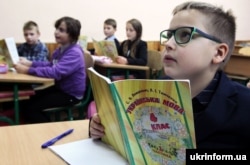 Fourth graders listen during a Ukrainian-language lesson at the secondary school in Vyshneve, Kyiv region.