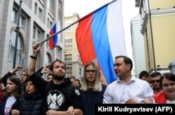 Candidates Lyubov Sobol (center) and Ivan Zhdanov (right) attend a rally against efforts to stop opposition candidates from registering for elections to the Moscow City Duma in central Moscow on July 14.