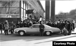 Curious residents inspect an American automobile on the streets of Kyiv.