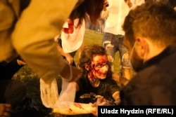 A female demonstrator who'd been beaten by police sits on the street in Minsk during the first postelection protest on the night of August 9-10.