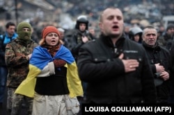 Protesters sing the Ukrainian national anthem in Independence Square on February 22.