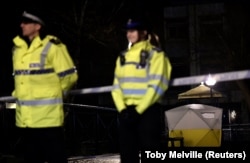 British police stand guard beside a cordoned-off area in Salisbury.