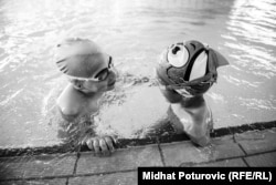 Ismail chats with a friend in the pool