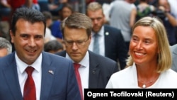 Macedonian Prime Minister Zoran Zaev (left) and European Union foreign policy chief Federica Mogherini walk through the Old Bazaar in Skopje on September 13.