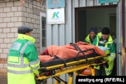 A resident is taken away on a stretcher on November 28, 2014, the day of the mass fainting incident.