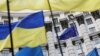 Ukrainian flags and the EU flag are seen during a mass rally in front of the Ukrainian cabinet of ministers building in Kyiv.