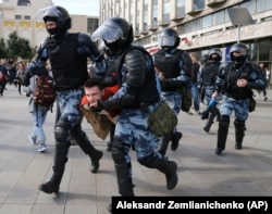 Police forcibly detain a protester during a rally in the center of Moscow on August 3.