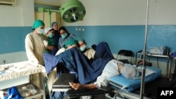 Nurses deliver a baby in the maternity ward of a hospital in Mazar-e Sharif.