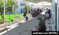 A crowd of people wait in line outside the offices of Turkmenistan's Migration Service in the eastern city of Turkmenabat.