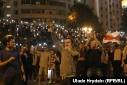 Protesters hold cellphone flashlights aloft at a protest rally on August 9-10.