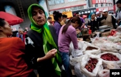 Ethnic Uyghurs and Han Chinese at a market in Urumqi in the Xinjiang region.