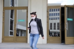 Svyatlana Tsikhanouskaya is shown leaving the Central Election Commission after she submitted documents necessary to register her own presidential campaign on May 15.