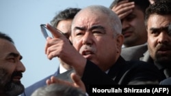  Then-Afghan Vice President Abdul Rashid Dostum (center) at Hamid Karzai International Airport in Kabul in July 2018