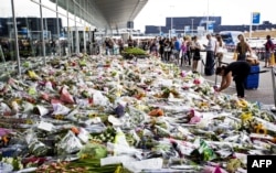 Bouquets in tribute to the victims at Amsterdam's Schiphol airport shortly after the tragedy. Almost 200 of the 298 people killed in the disaster were Dutch nationals.