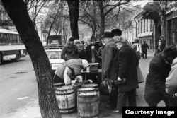 People form a line to buy herring in Kyiv.