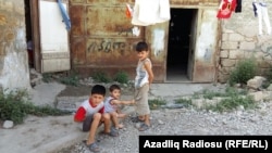 An Azerbaijani refugee family, originally from Nagorno-Karabakh, living in a storage room in Baku, pictured in 2016