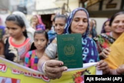 A Hindu refugee who migrated from Sindh Province in Pakistan displays her passport in Ahmadabad, India.