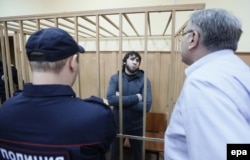 Zaur Dadayev (center), one of the main suspects in Nemtsov's killing, stands in a cage in a Moscow courtroom on August 25.