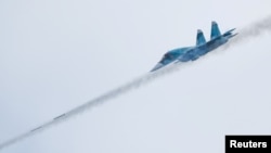 A Russian Sukhoi Su-34 fighter bomber fires missiles during a competition outside Ryazan, Russia.