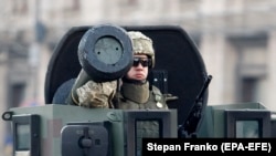 A Ukrainian soldier rides with a Javelin anti-tank missile as he takes part in a rehearsal of a military parade in downtown Kyiv in August 2018.