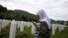 Hajra Catic prays near the grave of her husband in Potocari on June 23. She is still looking for her son, Nihad, who was 26 when Srebrenica fell.