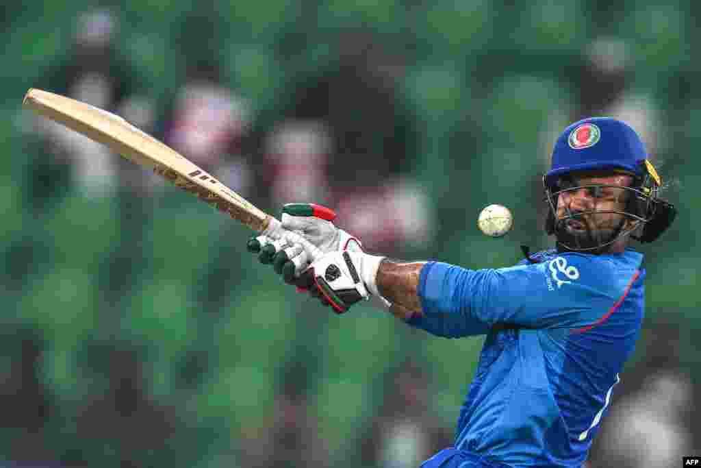 Afghanistan's Mohammad Nabi is hit by the ball during a one-day international cricket match against England in Lahore, Pakistan. 