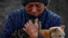 A Ukrainian woman holds her cats amid an evacuation of civilians in the Ukrainian town of Pokrovsk.&nbsp;