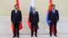 Chinese leader Xi Jinping, Russian President Vladimir Putin, and Mongolian President Ukhnaa Khurelsukh pose for a photo at the Shanghai Cooperation Organization summit in Uzbekistan in 2022.