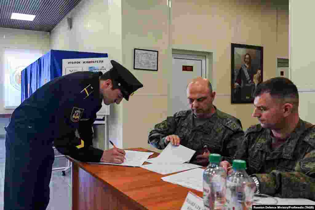 A Russian sailor votes in the March 2024 presidential election near a portrait of Peter the Great, in the Tartus naval facility. In 2017, Russia&nbsp;signed a 49-year lease&nbsp;on the Hmeimim base, and the Tartus naval facility (pictured) which was first established by the Soviets in 1971. Those agreements have been rendered meaningless by the collapse of the Assad government in Syria. &nbsp;