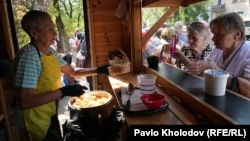 People line up for a free meal from a charity in Kyiv on September 3.