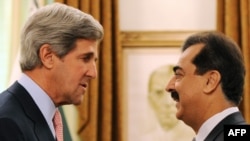 Pakistan's Prime Minister Yousuf Raza Gilani (right) shakes hands with U.S. Senator John Kerry in Islamabad before their talks today.