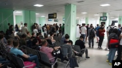 Russians wait at a public service center in Almaty, Kazakhstan, on September 27.