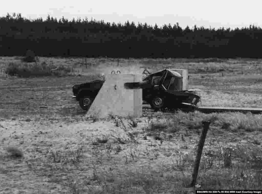 A vehicle smashes into a steel barrier at a secret testing location in East Germany where obstacles to prevent people speeding to freedom through East Berlin&#39;s checkpoints were tested. This 1980 photo is one of several held in Germany&#39;s Stasi Records Archive that reveal the lengths to which East Germany&#39;s authorities went to ensure anyone trying to escape the communist state would be stopped, or killed in the process.