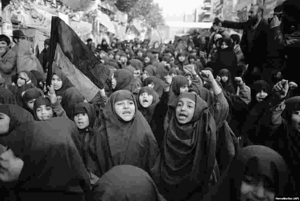 Iranian orphan girls in chadors demonstrate outside the embassy on November 27, 1979, demanding the return of the shah for prosecution.