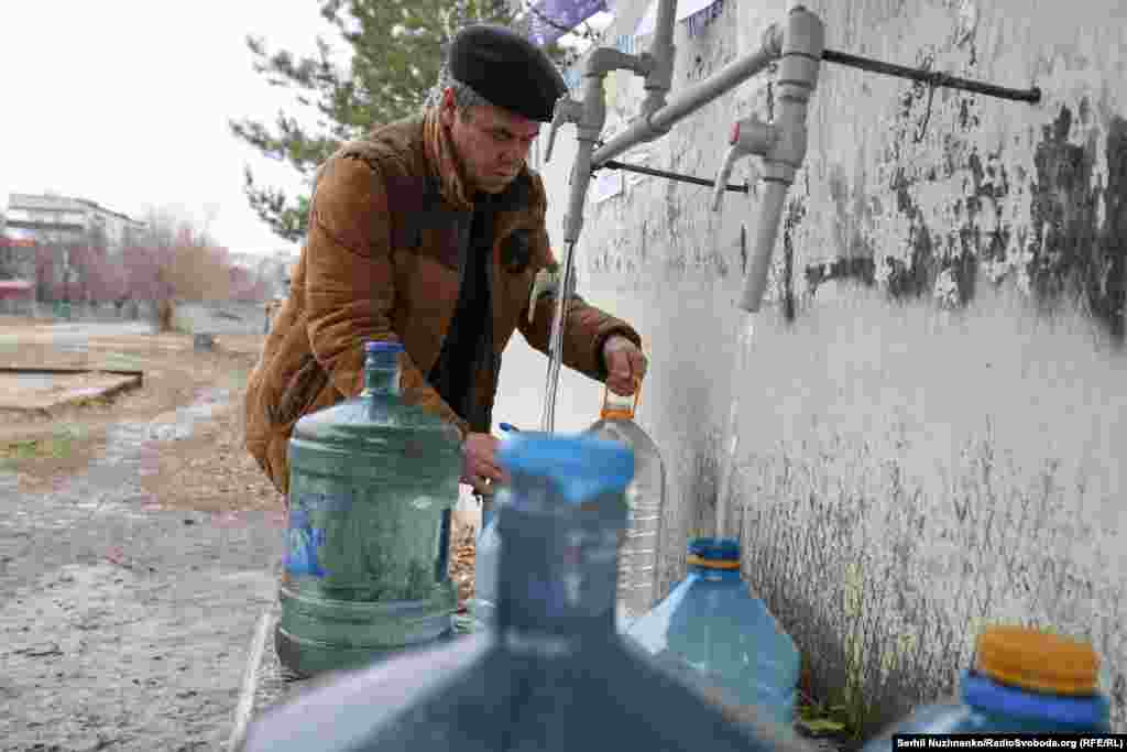 A Pokrovsk resident collects water from one of a handful of supply points in the city. One of the biggest challenges for Pokrovsk&#39;s residents is sourcing water. Locals say that Russian forces destroyed water pumping stations outside the city in August 2022, and since then most water has been sourced from tankers organized by local government and aid organizations.&nbsp;&nbsp;