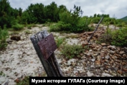 The graves of prisoners are marked with signs, but the names have faded.